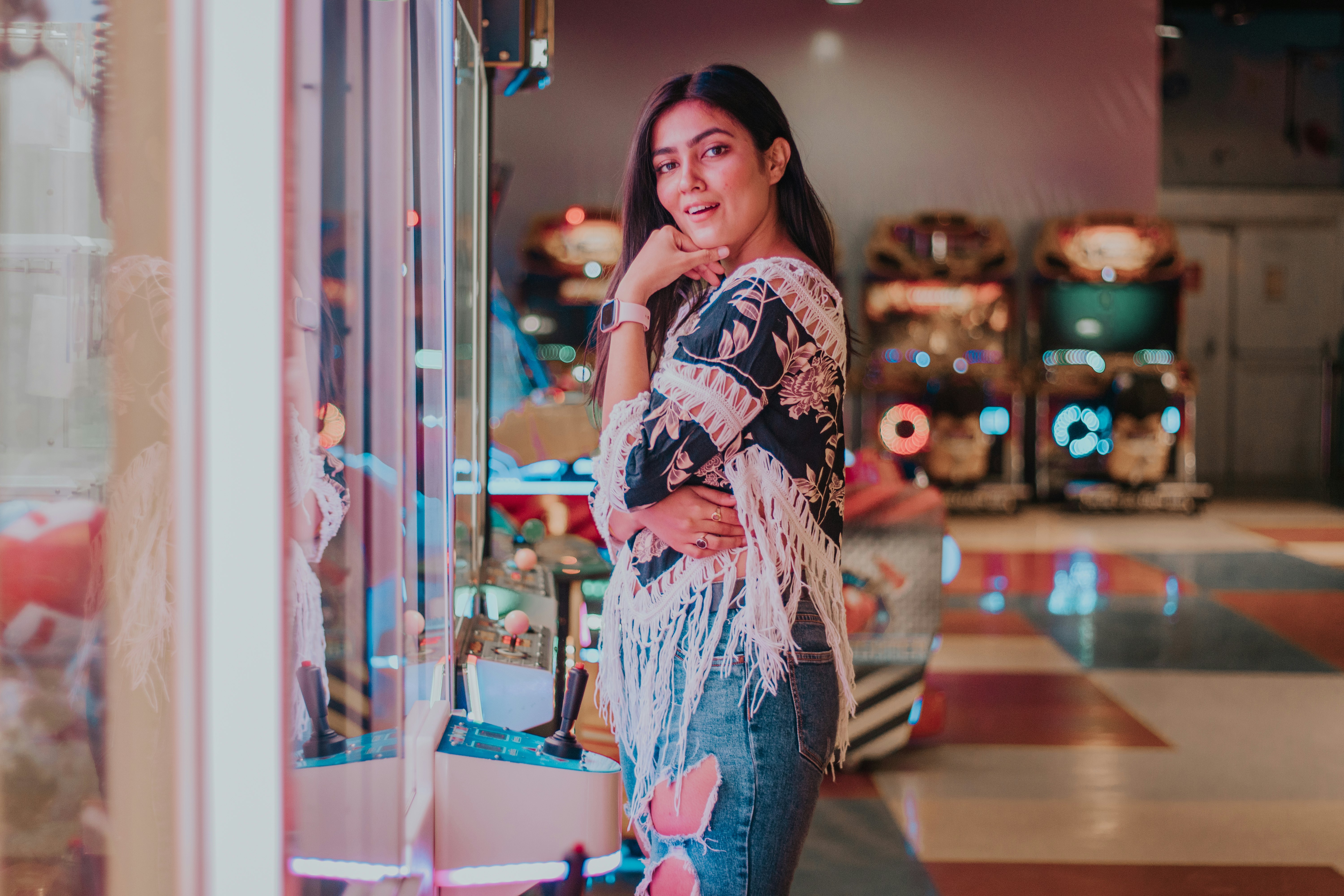 woman in blue denim jeans standing near glass wall